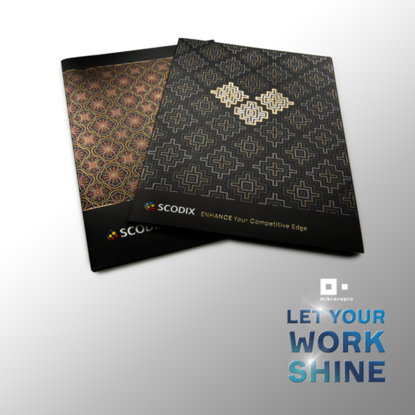 LetYourWorkShine_04 Two decorative brochures with intricate gold patterns, SCODIX branding, and the slogan 'LET YOUR WORK SHINE' against a gray gradient background.